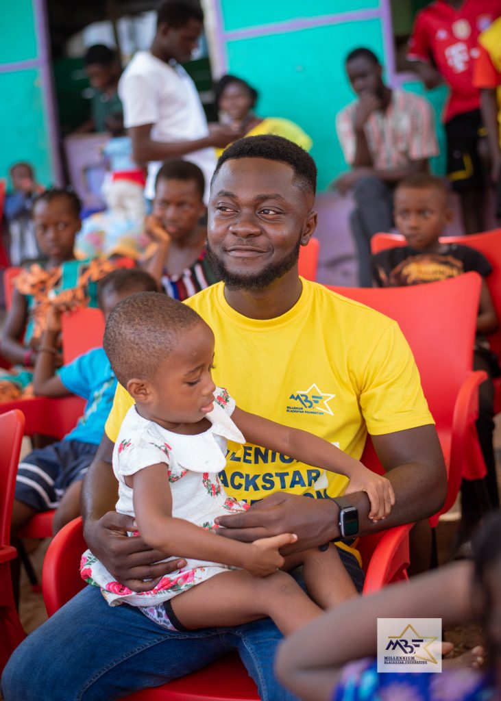 Founder of Millennium Blackstar Foundation Ghana with orphan